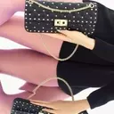 Valentino Garavani Rockstud Spike Handbag: A Study in Reflection and Reimagination